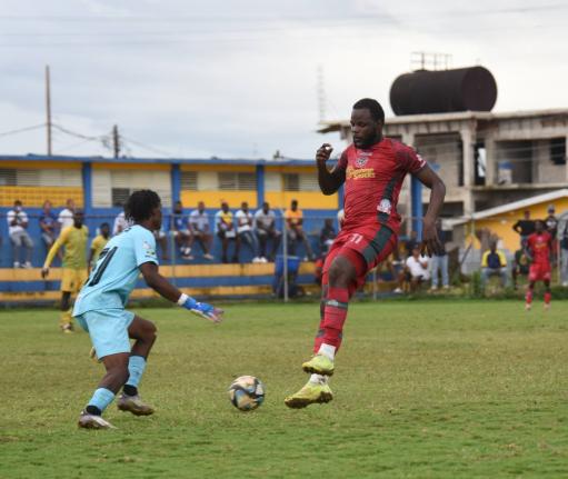 Montego Bay United’s Jourdain Fletcher (right) is challenged by Treasure Beach F.C’s goalkeeper Mowey Morgan (left) during their Jamaica Premier League game at St. Elizabeth Technical High (STETHS) Sports Complex on Sunday, January 4, 2026.