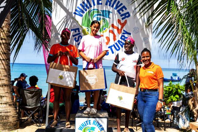 Excitement overflowed in the water, along the shoreline,  and at the winner’s podium as teenage female participants in Swim for the Sanctuary kept Tazhna Williams (right), public relations & corporate events executive at Massy Distribution Jamaica Limit