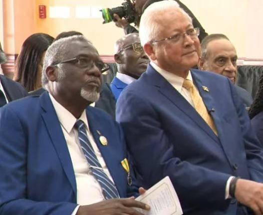 Justice and Constitutional Affairs Minister Delroy Chuck (right) sits with St James Custos Bishop Conrad Pitkin during the commissioning of 28 new justices of the peace for St James at the Grand-A-View Events Place in Montego Bay, St James, last Friday.