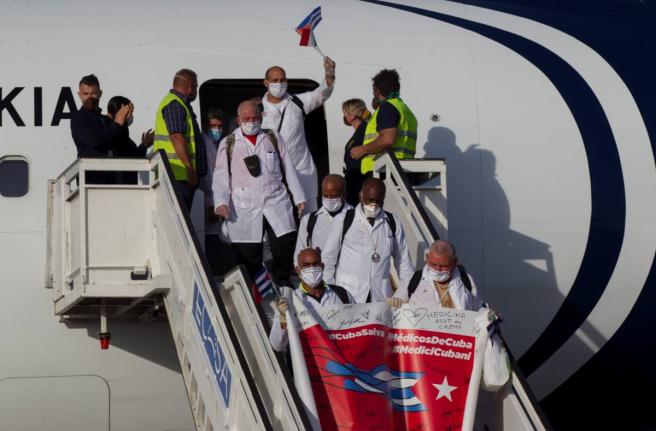 Cuban doctors arrive at the Jose Marti International Airport in Havana, Cuba, June 8, 2020, after travelling to Italy to help with the COVID-19 emergency response. (Ismael Francisco/Pool via AP, File)