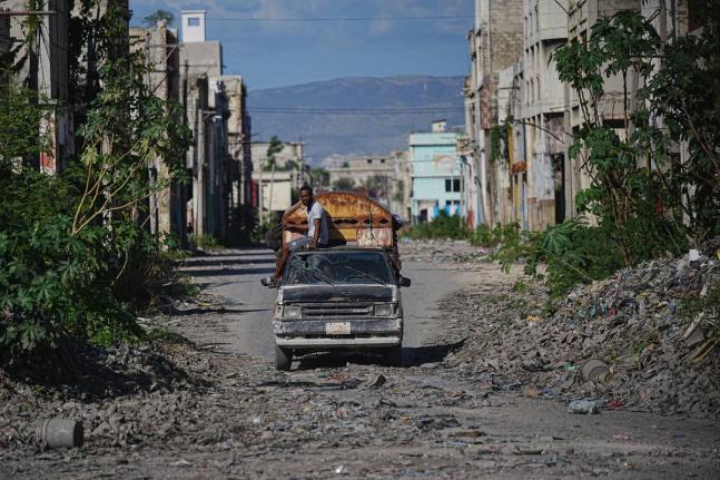 A local travels on public transportation through a gang-controlled area of Port-au-Prince, Haiti, Monday, January 19, 2026.