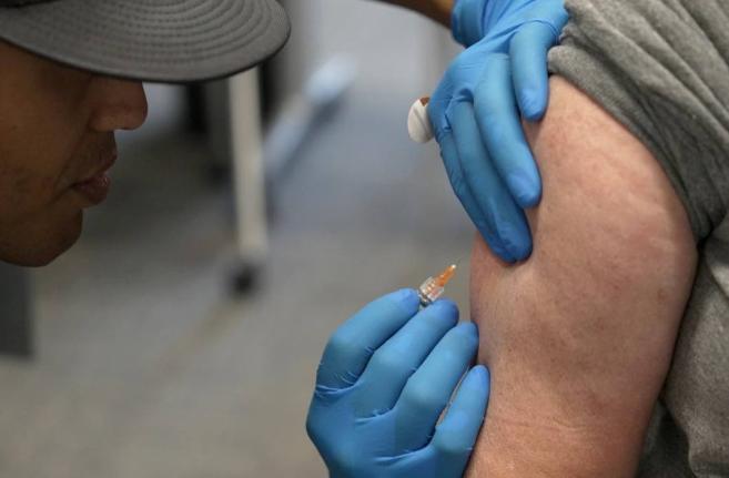  Matt Caldwell, left, a Lubbock Fire Department official, administers a measles, mumps and rubella vaccine to Clair May at the Lubbock Health Department, February 26, 2025, in Lubbock, Texas.