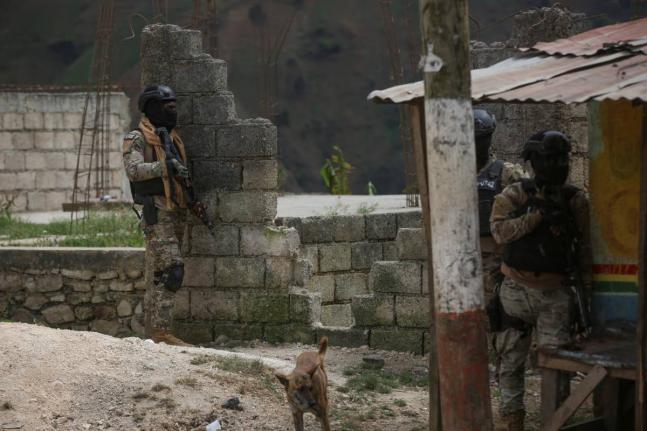 Police officers stand guard during an anti-gang operation in the Kenscoff neighbourhood of Port-au-Prince, Haiti, Monday, February 3, 2025. (AP Photo/Odelyn Joseph)