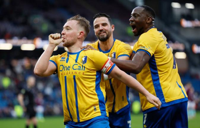 
Mansfield Town’s Louis Reed (left) celebrates scoring during the English FA Cup fourth-round football match against Burnley in Burnley, England, yesterday.