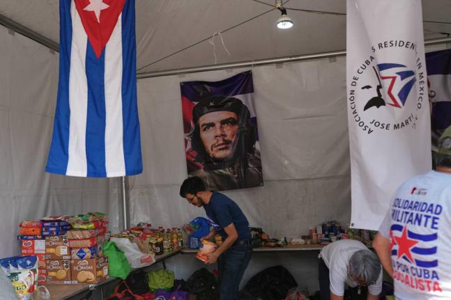 A volunteer arranges supplies at an aid collection center for Cuba in Mexico City's Zocalo on February 16, 2026. 