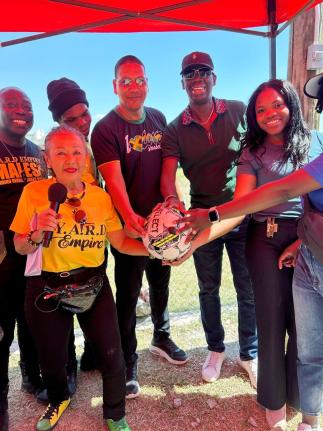 Member of Parliament for Central Kingston Donovan Williams (centre) holds a football alongside Peace Cup sponsor and creative strategist at YARD Empire Iris ‘Terri’ Salmon (front row, left) and other stakeholders ahead of kick-off for the Ash Wednesday