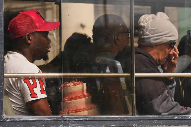 A commuter carries a cake in Havana, Cuba.