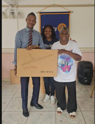Ramon Bremmer (left), the principal of Kew Park Primary School, accepts a Starlink package from  Rotary president Jean Powell. Looking on at centre is Tracie Campbell, the principal of Ferris Primary School.