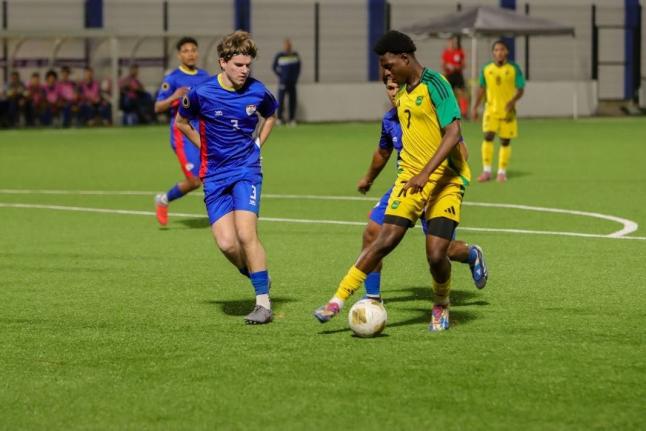 Jamaica Under-20’s Jahmarie Nolan turns away from Bonaire defender Ivar Bakelaar during the Concacaf Under-20 Qualifier at the Stadion Rignaal ‘Jean’ Francisca in Willemstad, Curaçao on Monday. Nolan was a scorer in yesterday’s 7-0 hammering of Tu