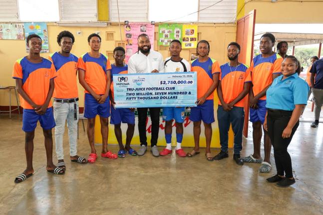 Chevon Lewis (centre), brand manager for MPowa at Wisynco, and Moniefa Morrison (right), brand ambassador, Wisynco, share a moment with the Tru Juice Football Club after handing over a symbolic cheque valued at $2.75 million on behalf of Wisynco brands —