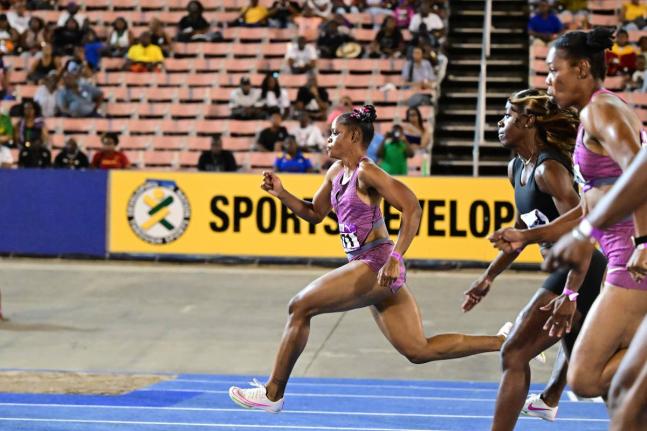 Tia Clayton (left) powers to victory in Section B of the women’s 60 metres at last year’s Gibson McCook Relays. Clayton won in  7.02 seconds.