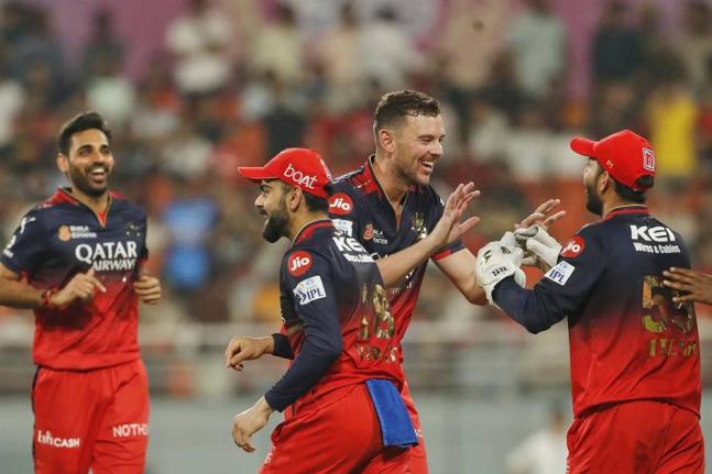 Royal Challengers’ Bengalaru’s Josh Hazlewood (second right) celebrates the dismissal of Pubjab Jings’ Azmatullah Omarzai with teammates during the Indian Premier League Qualifier 1 cricket match at Maharaja Yadavindra Singh Cricket Stadium in Mohali