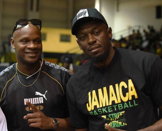 
Track and field legends Asafa Powell (left) and Usain Bolt made it their point of duty to support Jamaica’s push for a place at the FIBA World Cup during a qualifier against the Bahamas at the National Indoor Sports Centre on Thursday.