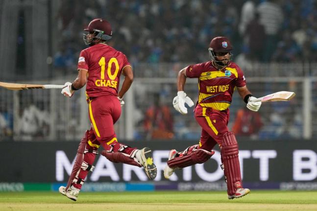 
West Indies’ captain Shai Hope (right) and batting partner Roston Chase run between the wickets during the T20 World Cup cricket match against India in Kolkata, India, on March 1.