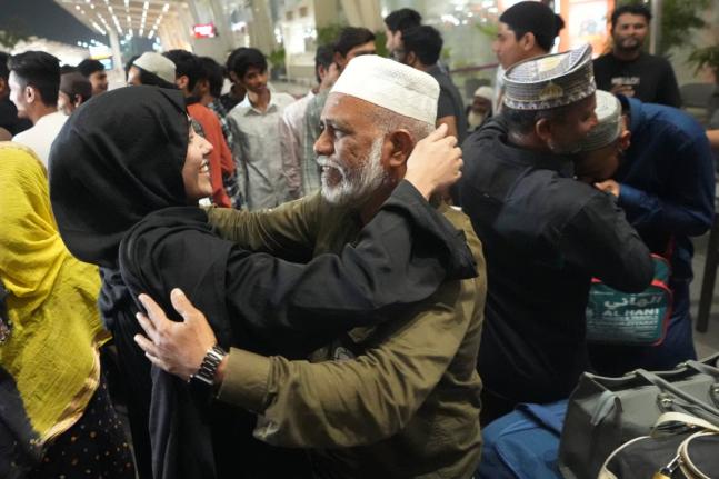 A man, centre right, breaks down as he hugs a relative at airport upon his arrival from Jeddah, in Ahmedabad, India, Wednesday, March 4, 2026. (AP Photo/Ajit Solanki)