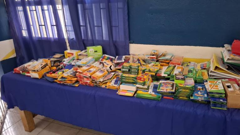Tables neatly arranged with donated school supplies that were prepared for distribution to students affected by Hurricane Melissa at Maud McLeod.