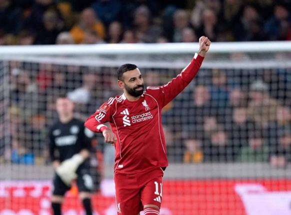 Liverpool’s Mohamed Salah celebrates after scoring his team’s  second goal of the game during an English FA Cup fifth round match against Wolverhampton Wanderers yesterday.