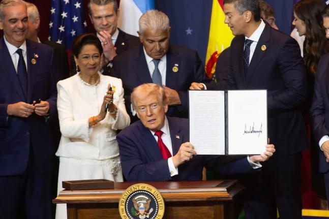 United States President Donald Trump is joined by Trinidad and Tobago Prime Minister Kamla Persad-Bissessar at the signing ceremony for the agreementt establishing the military alliance known as the Americas Counter-Cartel Coalition.