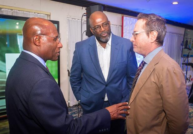 Minister of Industry, Investment and Commerce, Senator Aubyn Hill (left), engages in discussion with Acting Chief Executive Officer of the Jamaica Business Development Corporation (JBDC), Harold Davis (centre), and Deputy Head of Cooperation at the Europea