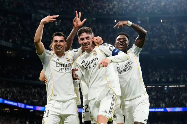 Real Madrid’s Federico Valverde (centre) celebrates after scoring his third goal during a first-leg round-of-16 Champions League football match against Manchester City in Madrid, Spain, yesterday.