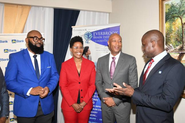 Dr O’Neil Dacres (right), corporate relations manager at JN Bank, has the captive attention of husband and wife and co-founders of Everbrook Brain Institute and Cognitive Clinic, Dr Steve Lawrence (left), a technology, curriculum, eLearning, AI and resea