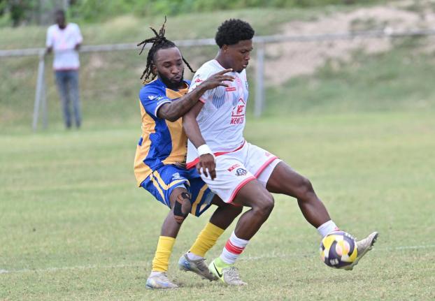 Orel Miller of Portmore United shields the ball from Harbour View’s Kenly Deacon during yesterday’s Jamaica Premier League match at the Ferdi Neita Park. Portmore won 4-2. 