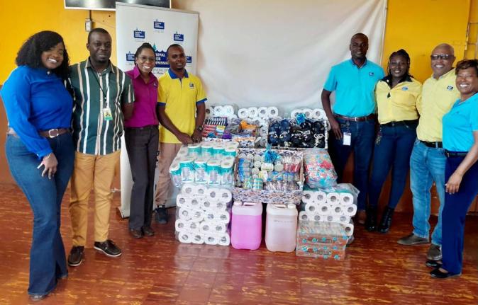NWC representatives share a moment with Manning’s Boys Home after donating essential items to the institution. In photo from left are;  Shanique Brown, team leader - distribution and maintenance (Control Center); Richard Aiken, manager, Manning’s Boys 