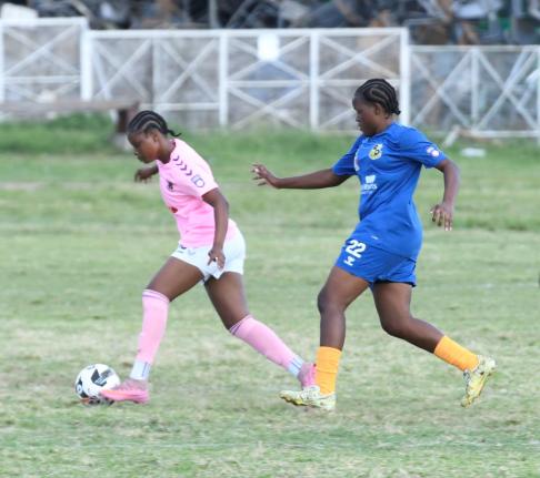 Antoine Lodge/Photographer 
Frazsiers Whip’s Kersha Thomas (left) dribbles away from Springers United’s Jasheika Harris during a Jamaica Women’s Premier League football game at the Excelsior High School field yesterday.