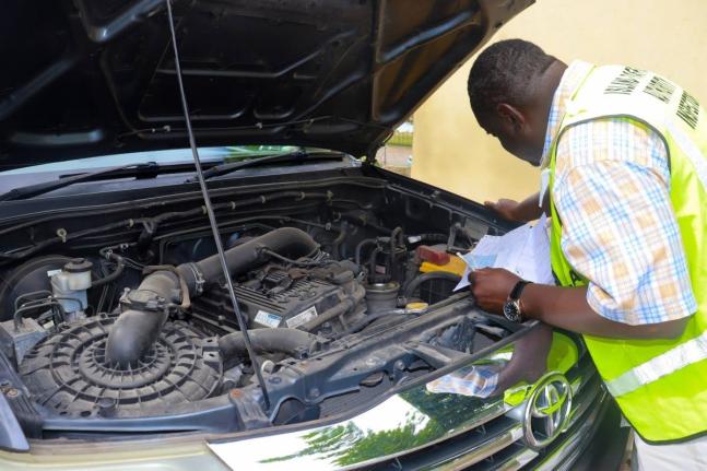 An Island Traffic Authority examiner checks the engine of a vehicle at one of the ITA's service hubs, as part of the fitness certification process.