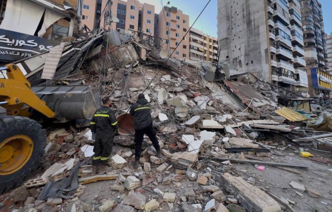Civil defense workers check a destroyed building that was hit by an Israeli airstrike in Dahiyeh, Beirut's southern suburbs, Lebanon, Tuesday, March 24, 2026. 