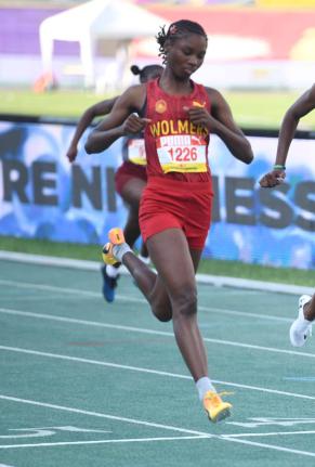 Wolmer’s Trust High School for Girls’ Natrece East cruises into the semi-final of the 100 metres on day one of the ISSA/GraceKennedy Boys and Girls’ Athletics Championships at the National Stadium yesterday.