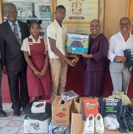  Donna Parchment-Brown hands over an inflatable mattress to Newell High School head boy Gary Blake on Friday. Also in the picture (from left) are Dr Adeniyini Bamedele, foundation board member; head girl Kimberley Thompson, and Principal Audrey Ellington. 
