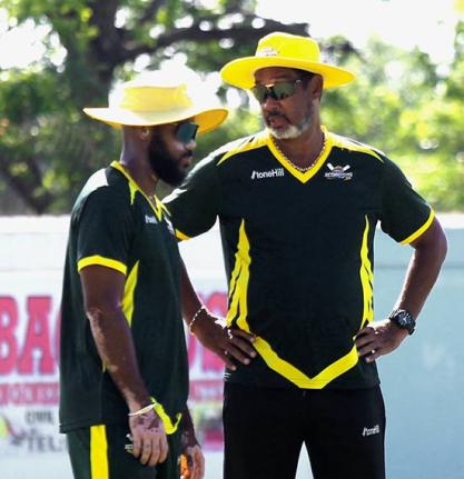 Jamaica Scorpions coach Robert Haynes (right) chats with captain John Campbell during the West Indies Championship cricket match against Barbados Pride at Chedwin Park on Wednesday.