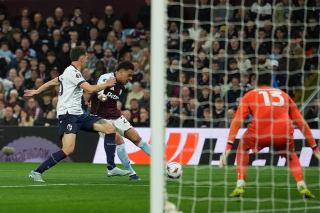 Aston Villa’s Morgan Rogers scores his side’s third goal during the Europa League quarter-final second leg match between Aston Villa and Bologna, in Birmingham, England, yesterday.